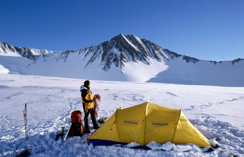 Climber and tent below a peak in Antarctica on the Climb Antarctica program