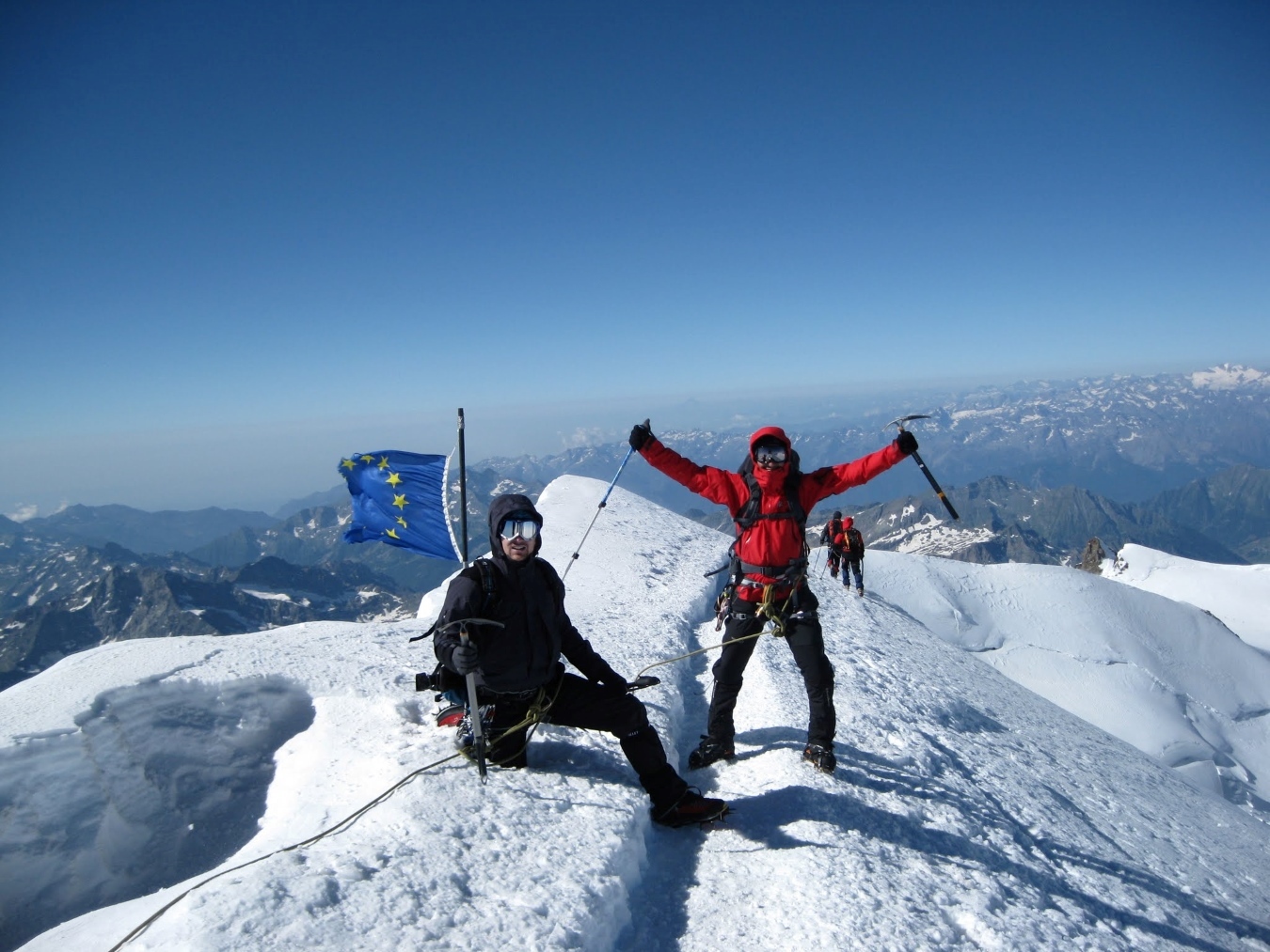 Two climbers on the summit of Signalkuppe, Monte Rosa region.