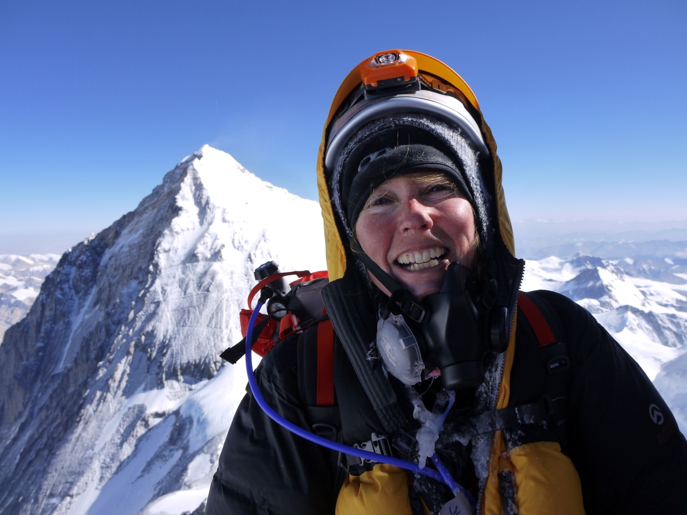 Happy female climber on the summit of Mt Lhotse with Everest behind