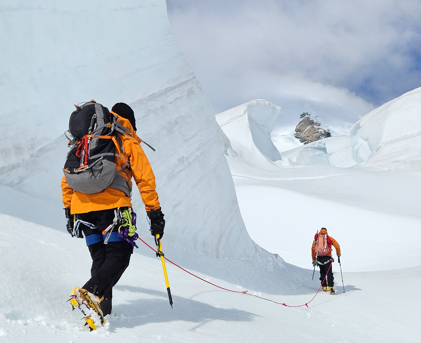 Climbers roped up for glacier travel may their way past large seracs of ice on the Tasman Glacier, New Zealand