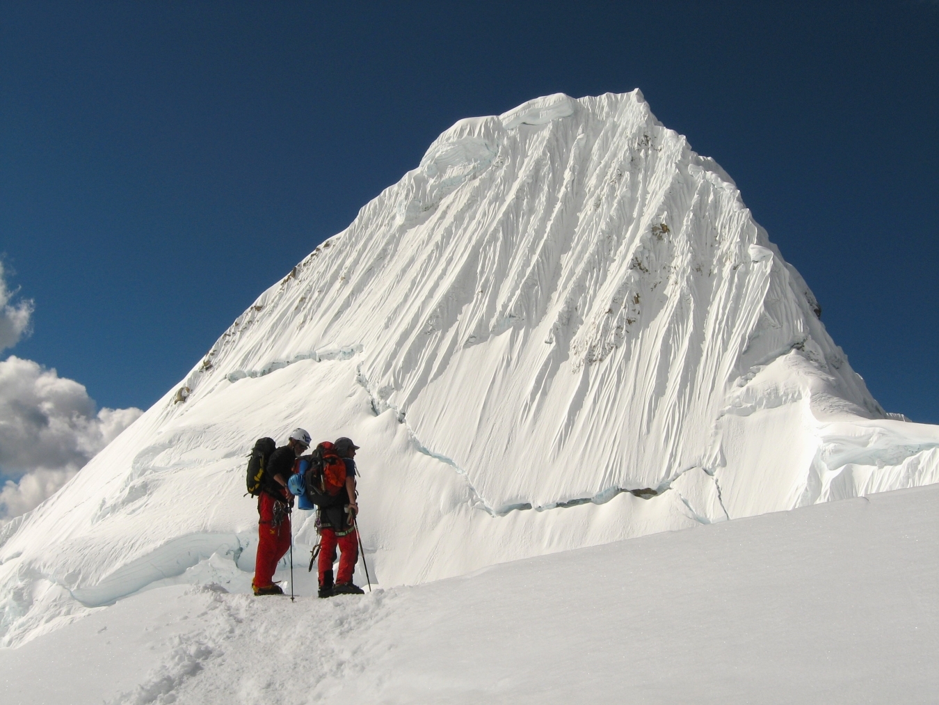 Climbers beneath Mt Alpamayo in Peru