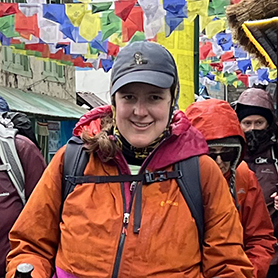 Kristi Berry treks through the busy village of Lukla, Nepal, prayer flags fluttering above