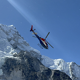 A helicopter takes off from Everest Base Camp