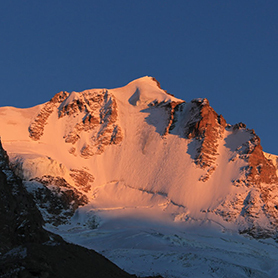 Gran Paradiso in the evening sun glowing pink and orange hues.
