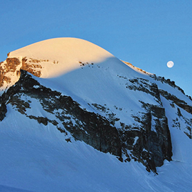The moon over the summit of Mont Blanc