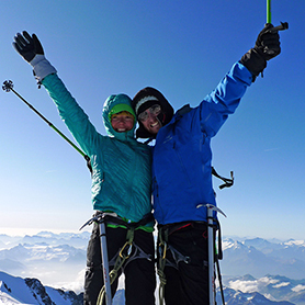 Two climbers on the summit of the highest peak in the European Alps, Mont Blanc.