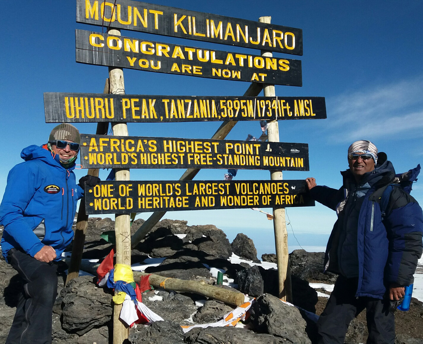 Two climbers celebrate on the summit of Mt Kilimanjaro highest peak in Africa