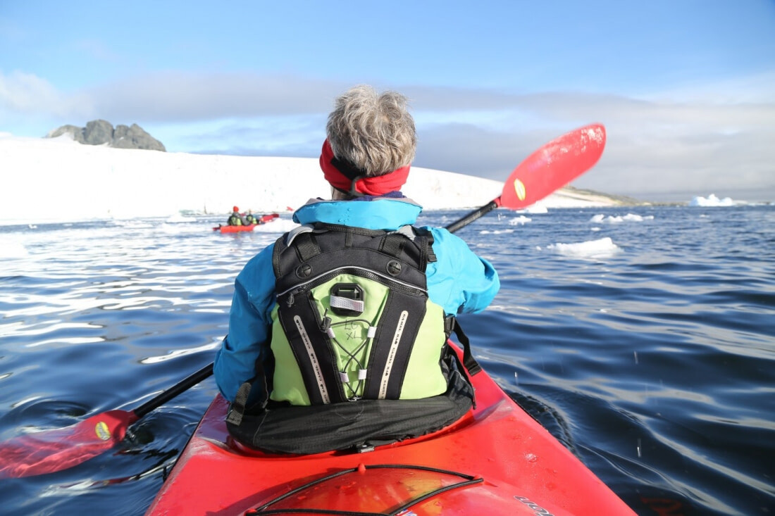 Kayakers enjoy the unique experience of paddling amongst icebergs on the Antarctic Peninsula