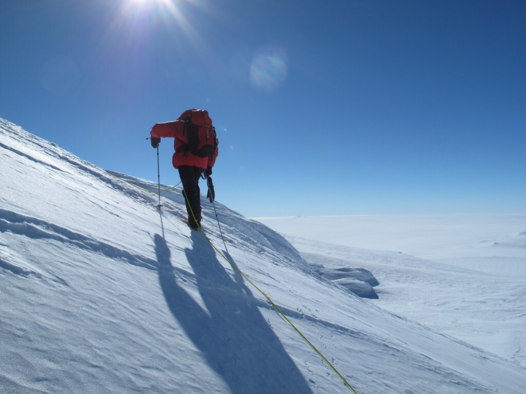 A climber on the slopes of Sidley with the expanse of Antarctica below.
