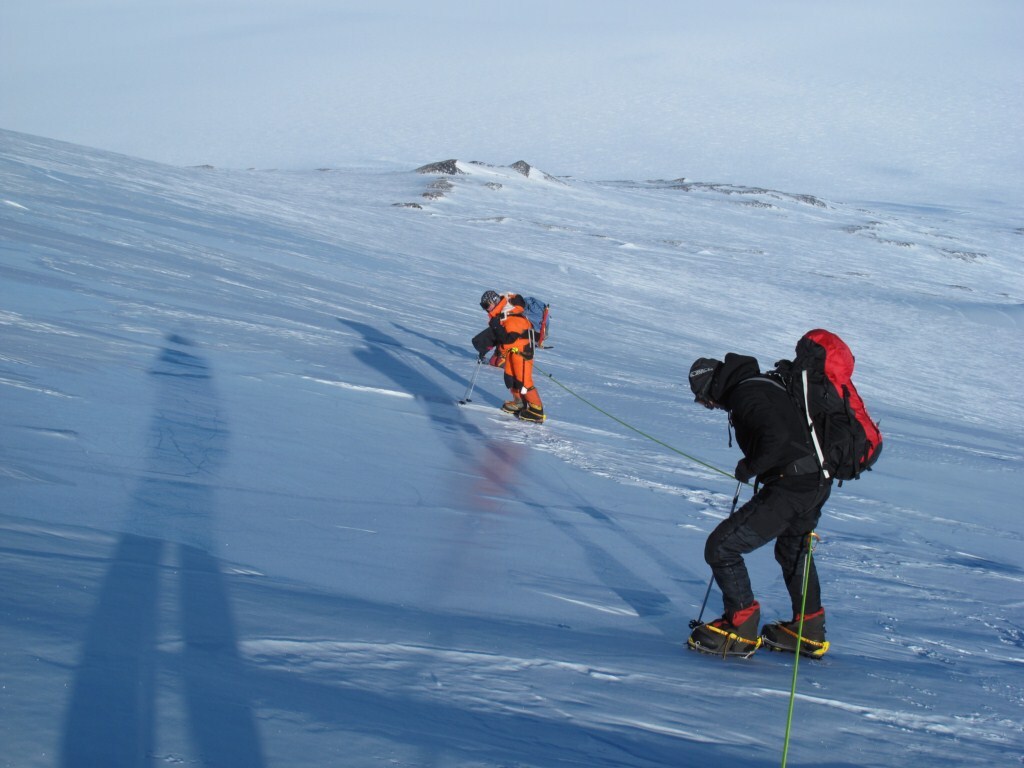 Heads down and legs moving! Two climbers grind their way up the slopes of Mount Sidley.