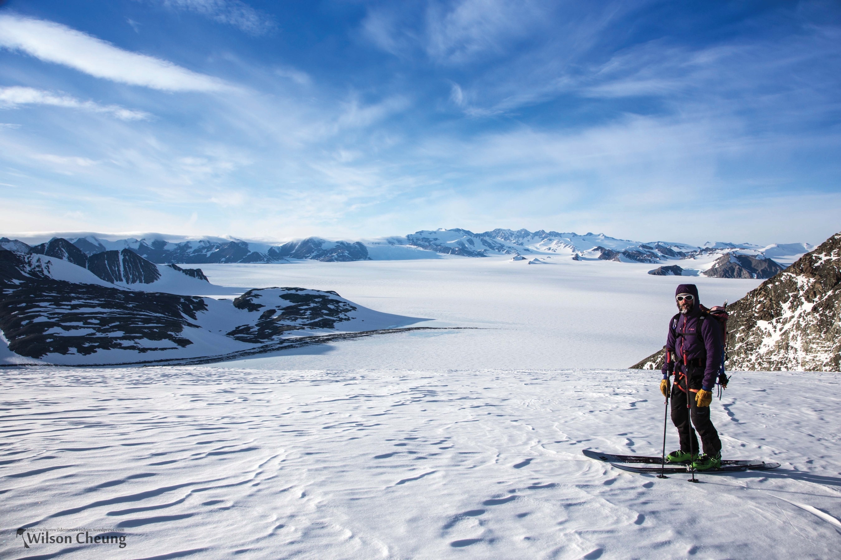A skier contemplates the vast Ellsworth mountains and glacier below
