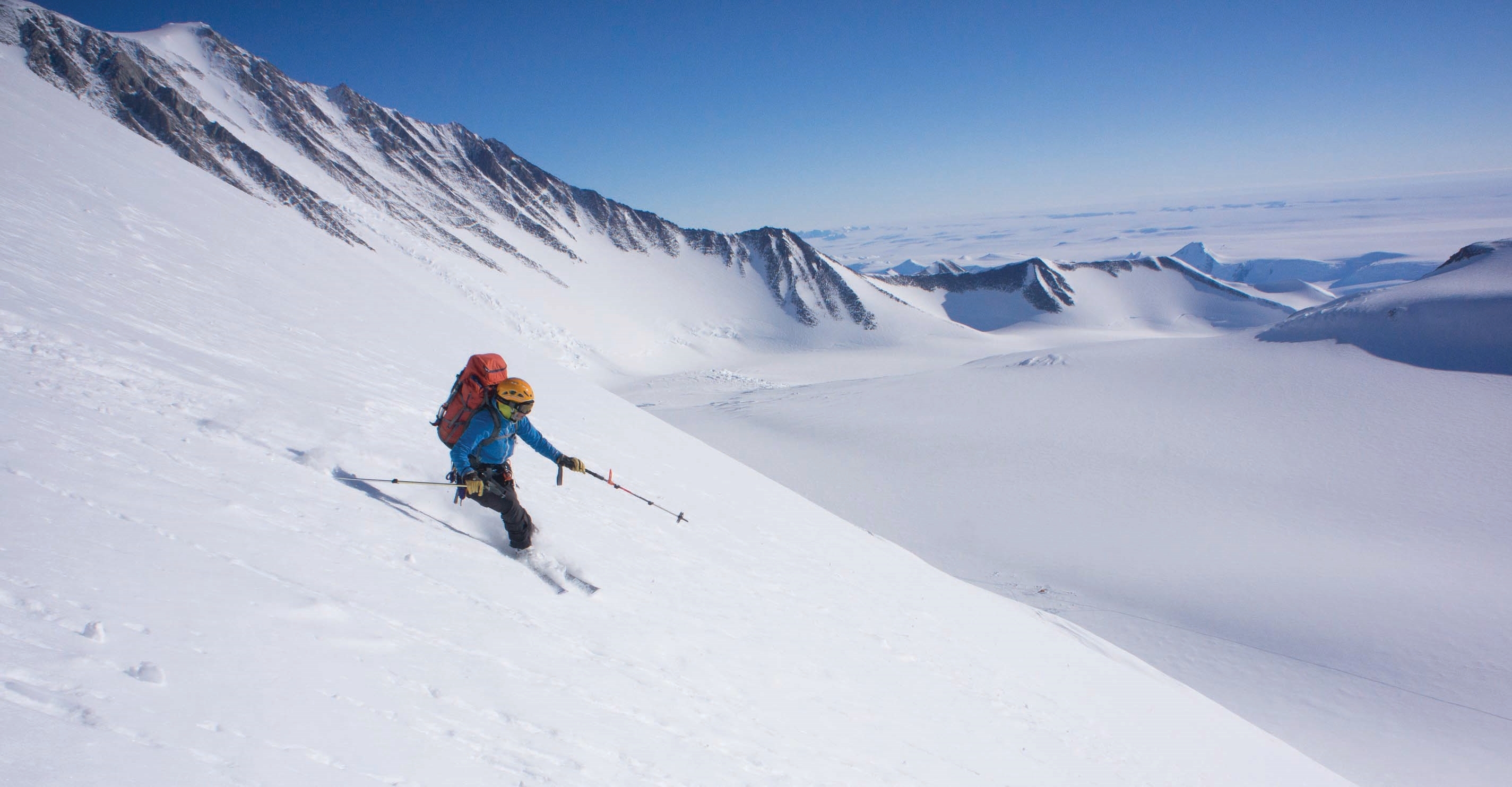 No queues on the slopes in Antarctica. A solo skier makes fresh tracks to the huge glacier below