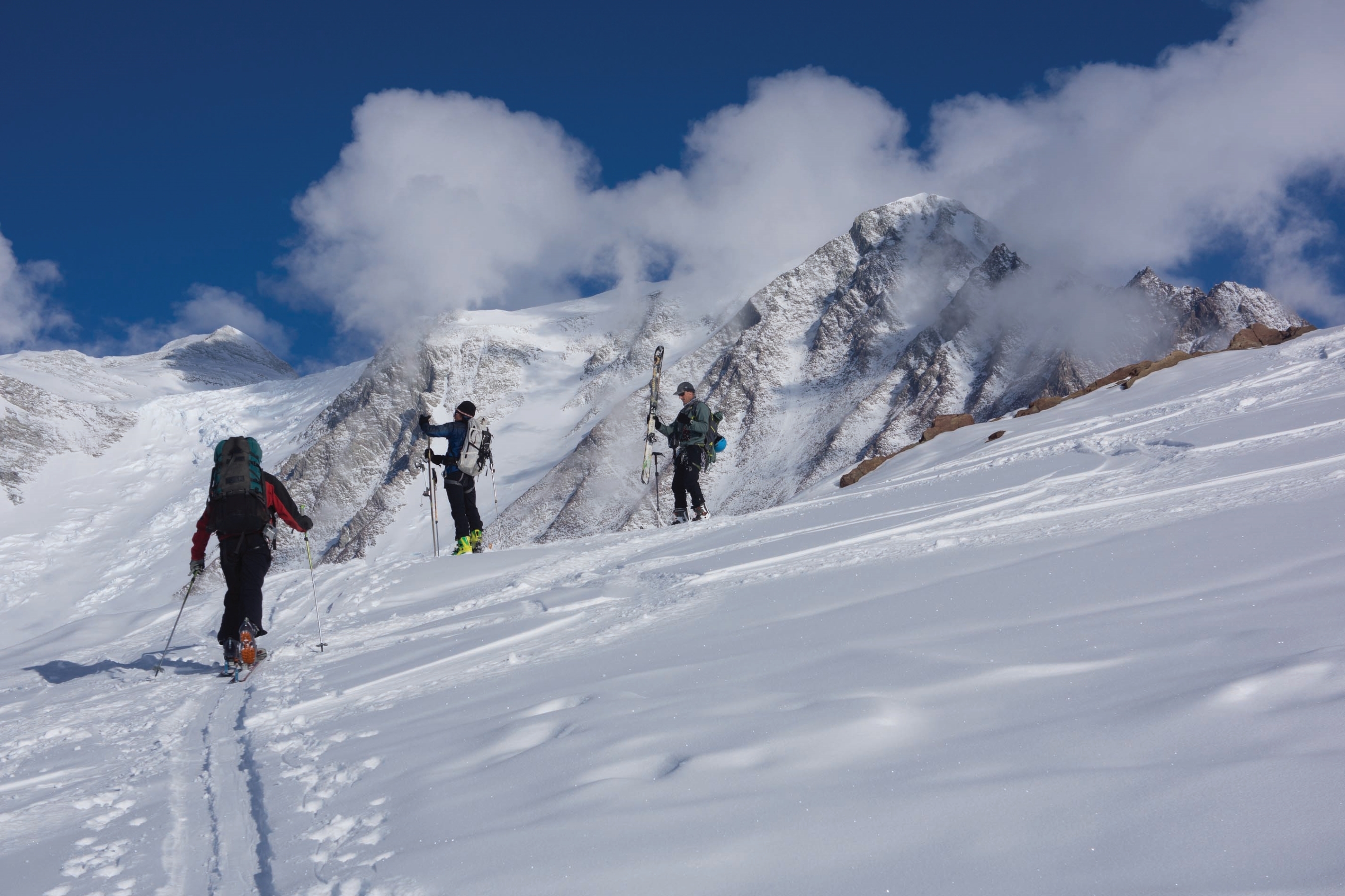 Ski touring in Antarctica, skiers take off their skins in anticipation of their next run!