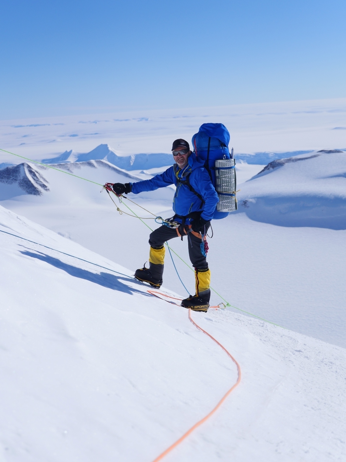 Climber on fixed ropes on Mount Vinson, the vast Antarctic expanse below