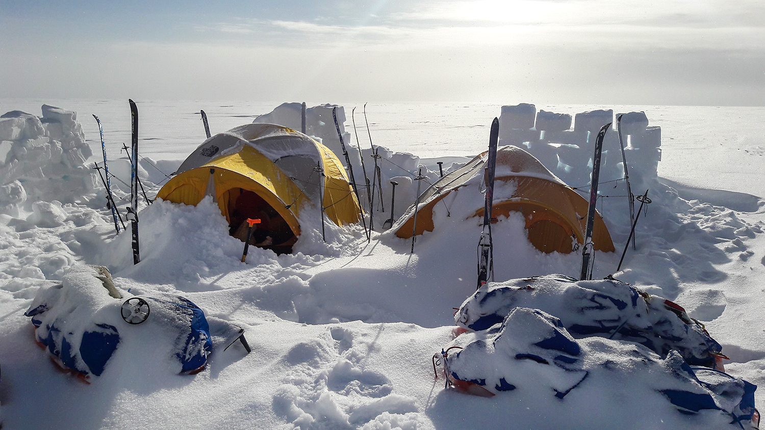 Camp on the Greenland Crossing with protective ice walls for the wind