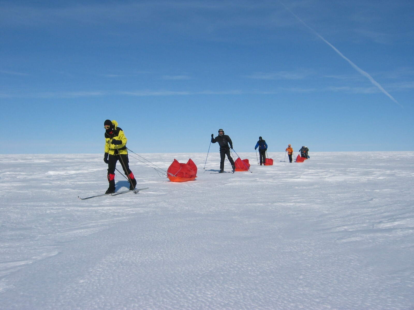 Sled hauling over the emty white expense on the Greenland Crossing