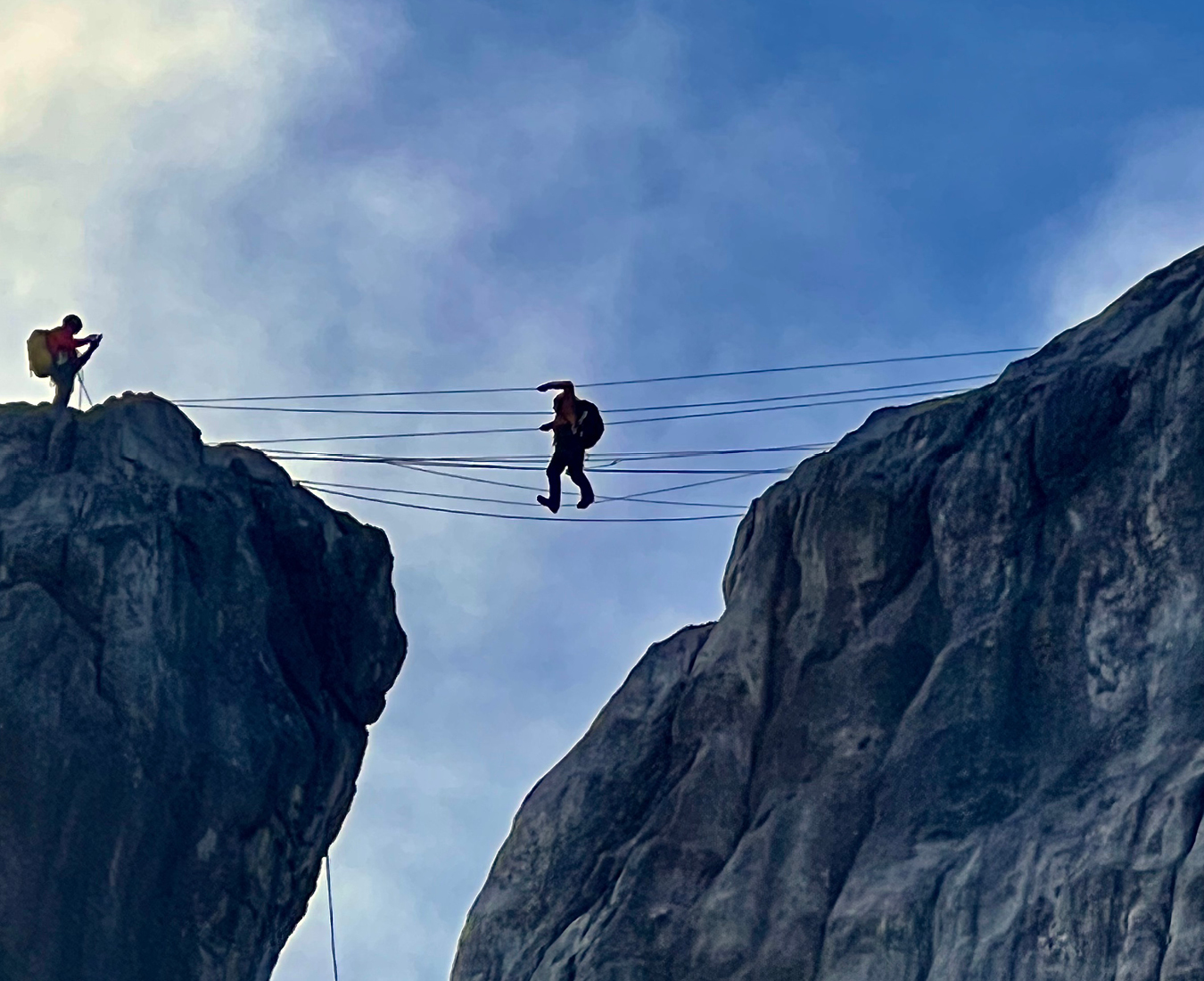 Looking up to climbers on the infamous Carstensz 3-wire bridge.