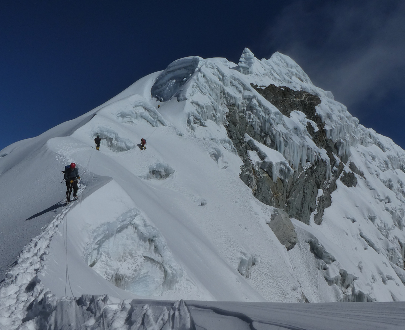 Climbers descending the ridge below the summit of Cholatse.
