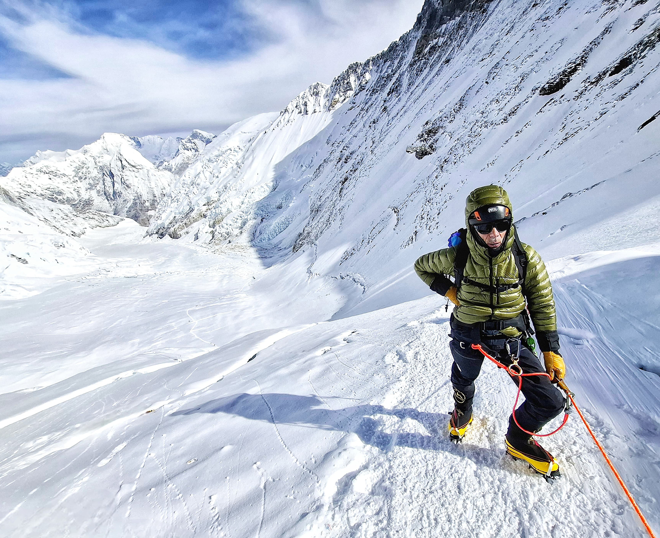 AC Climber Roland Carel climbs the lower reaches of the Lhotse Face, the Western Cwn opening out behind him with Pumori in the distance.