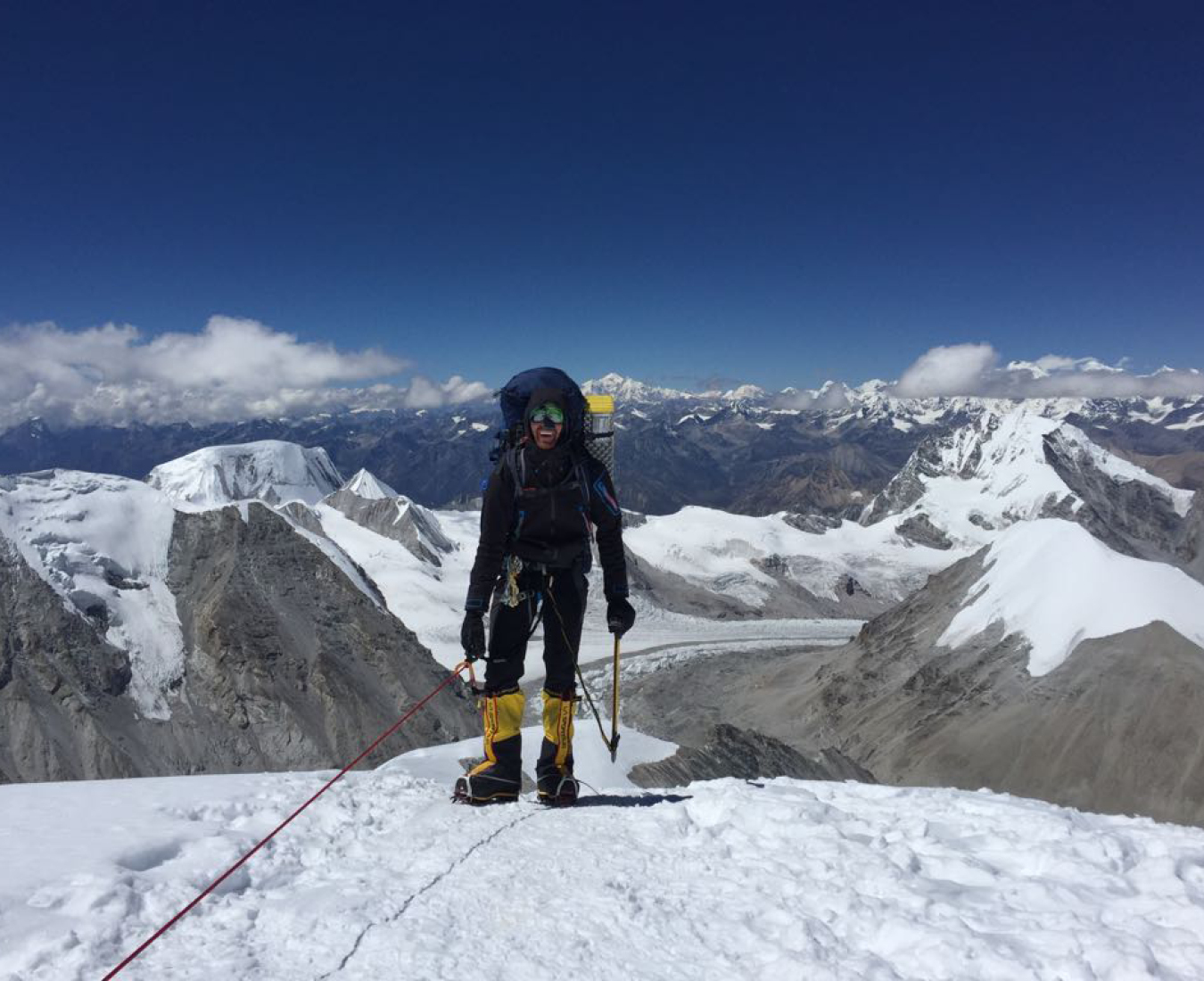 A climber tops out above the ice cliff towards the summit plateau on Cho Oyu in brilliant clear weather.