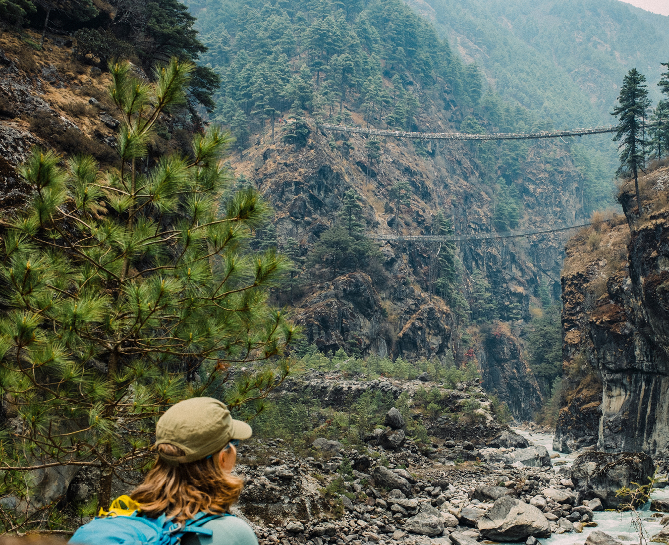 A trekker in the lower reaches of the Khumbu looks up at the twin bridges across the Dudhi Koshi river below Namche Bazaar.