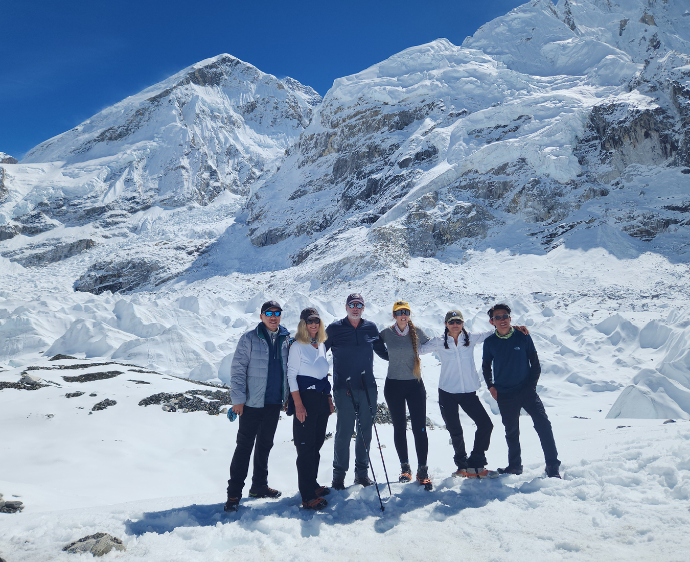 A team of trekkers revel in fresh snow at Everest Base Camp during the post monsoon season.