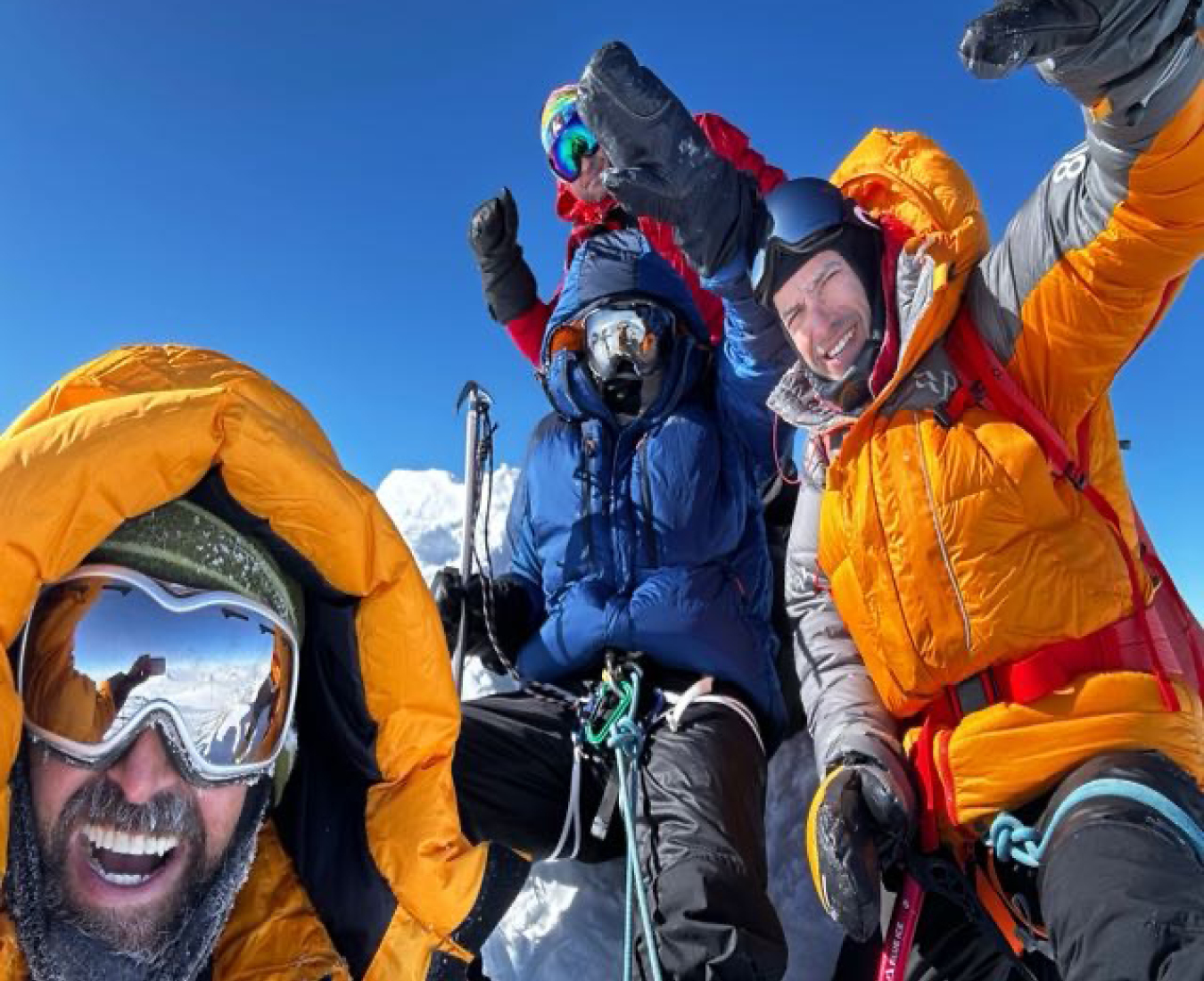 The V5 Vinson 2023/24 team on the summit of Antarctica's highest peak, Mount Vinson in bluebird conditions.