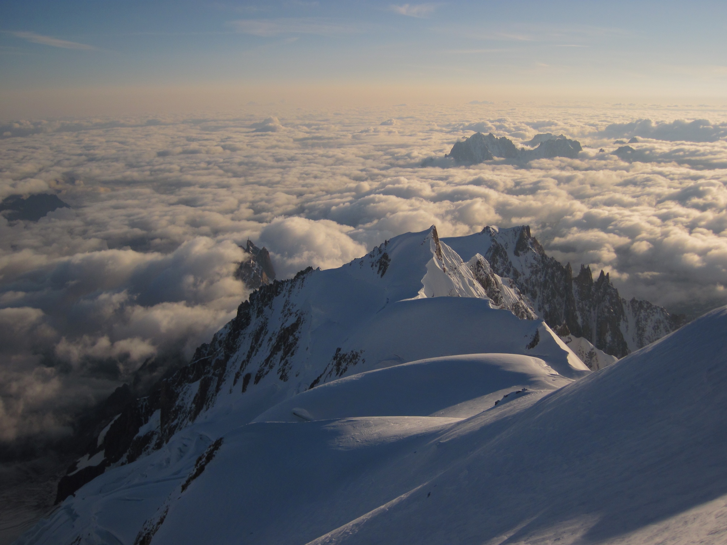 Dawn reveals the clouds below on Mont Blanc summit day