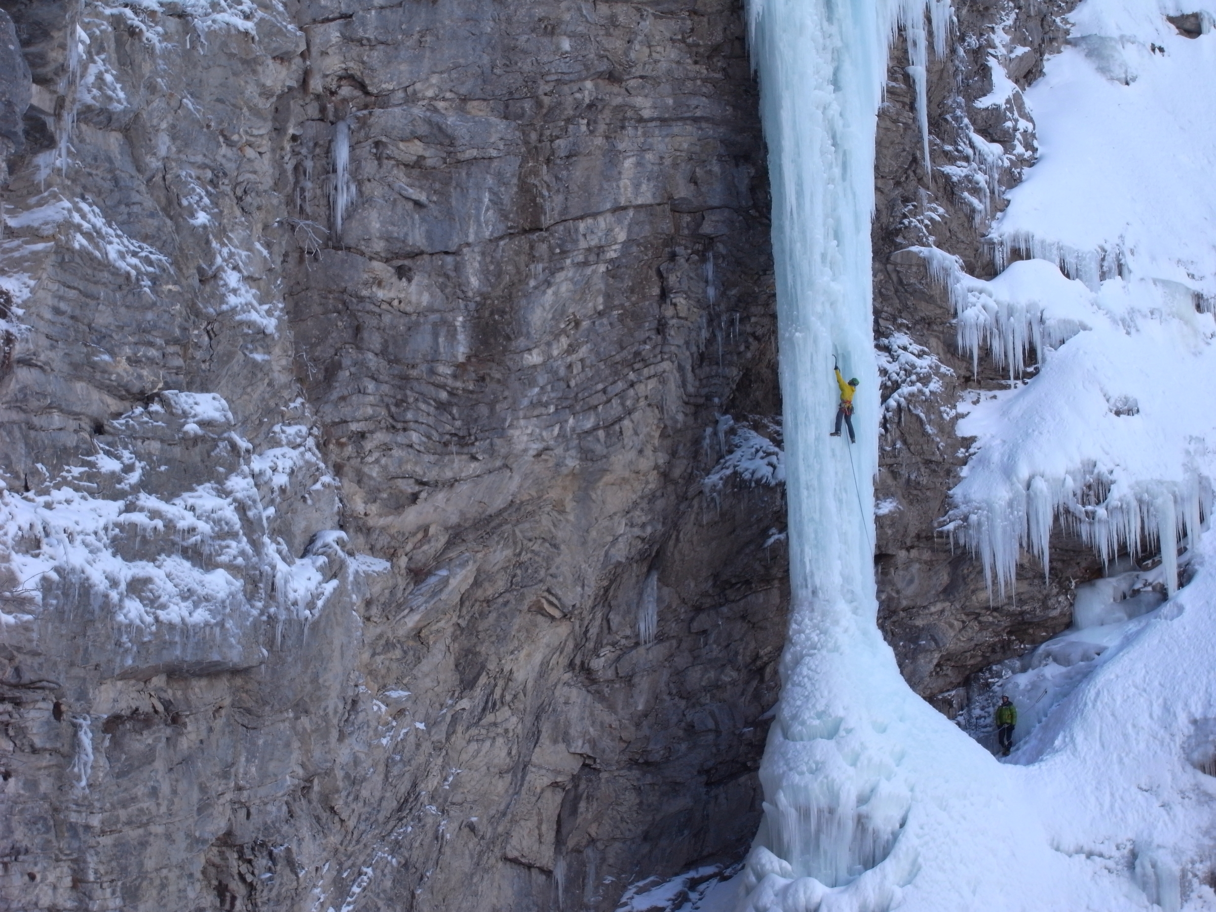 The size of the frozen waterfalls brought into perspective by a tiny climber mid way up the climb