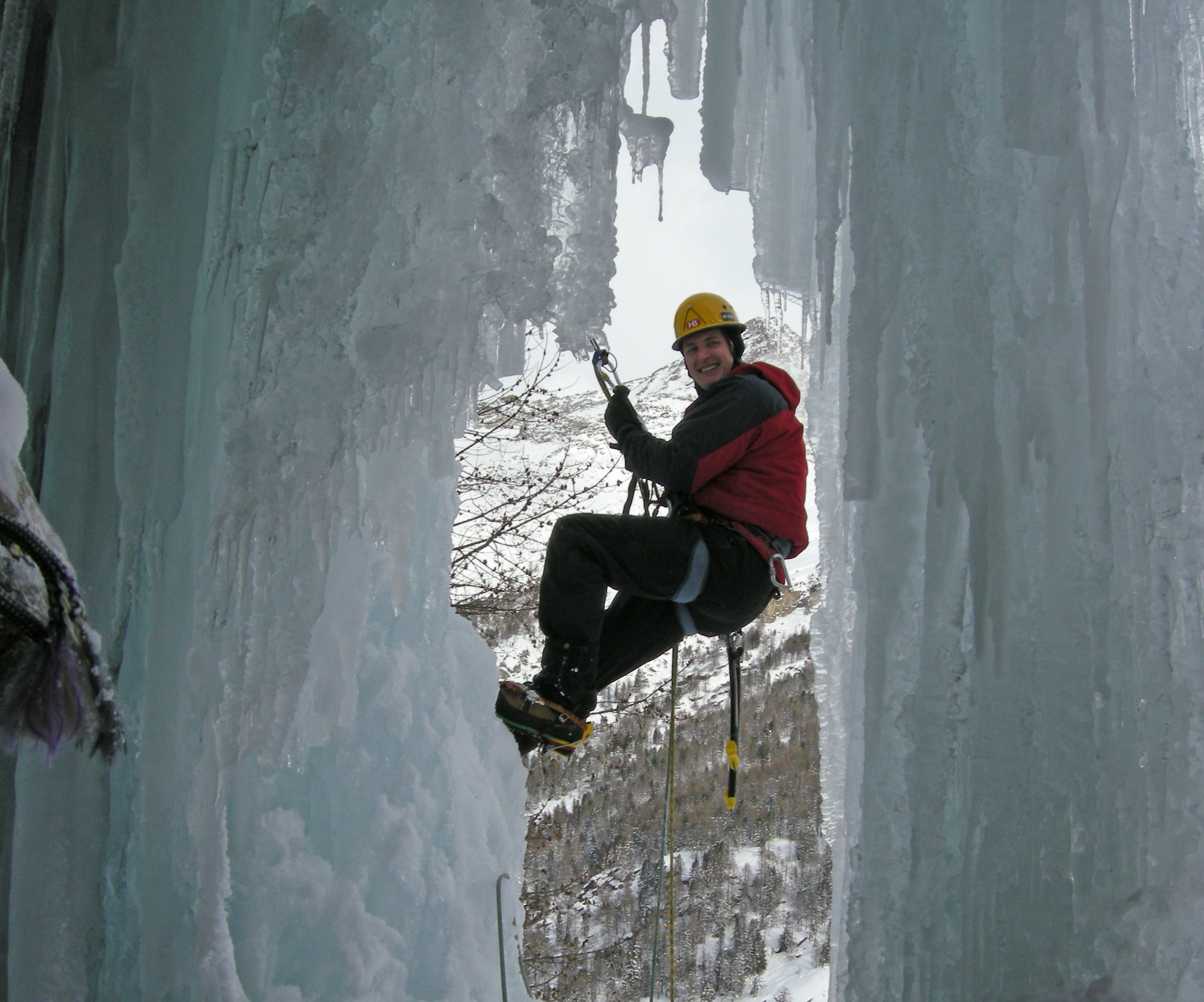A climber framed by frozen ice on Antares Val Savaranche