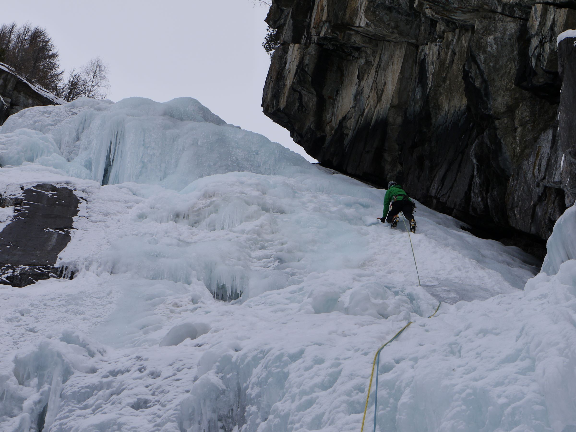 Climber with ice tools on lead at Lillaz