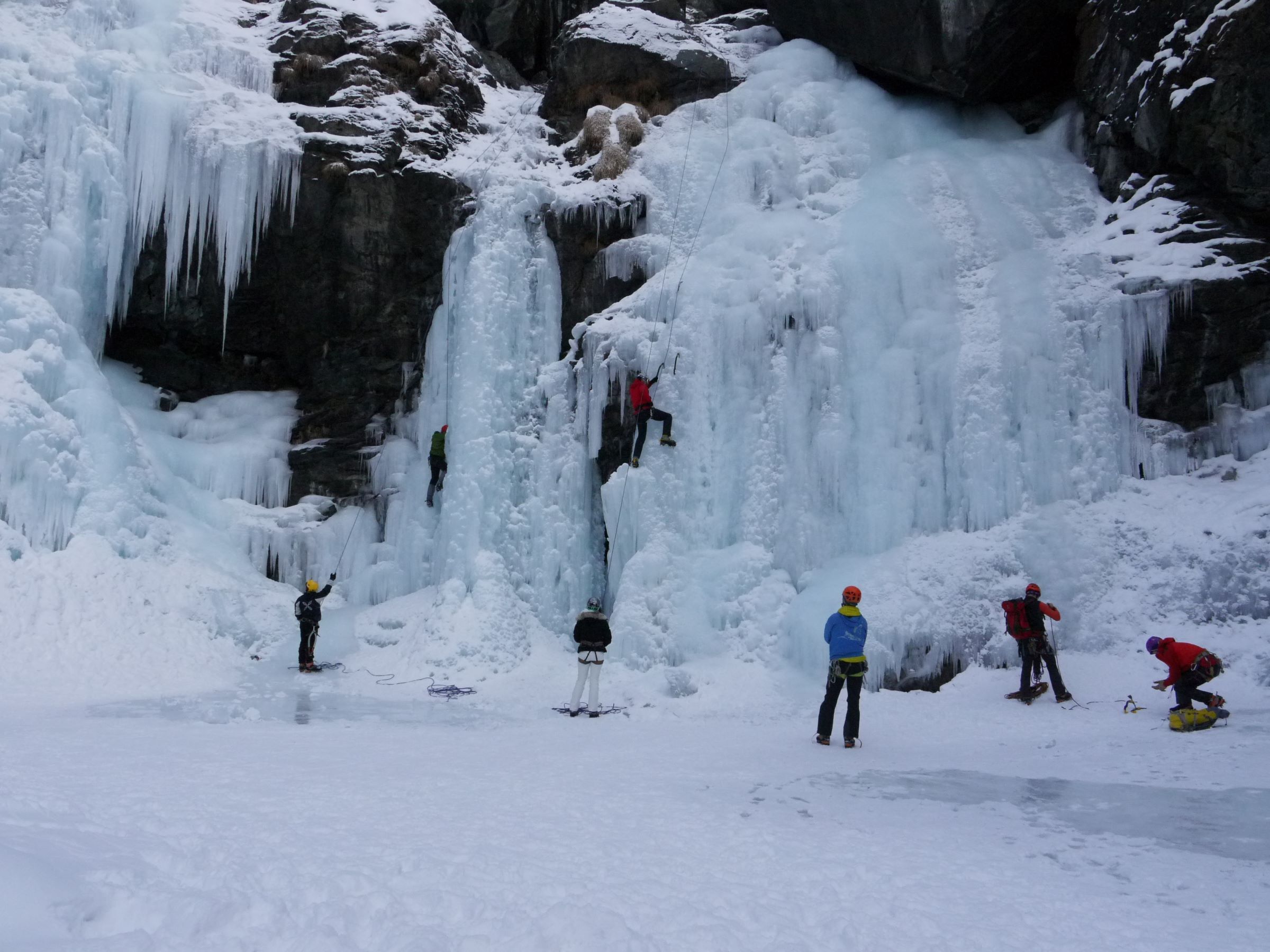A group of ice climbers on top rope as part of ice climbing course