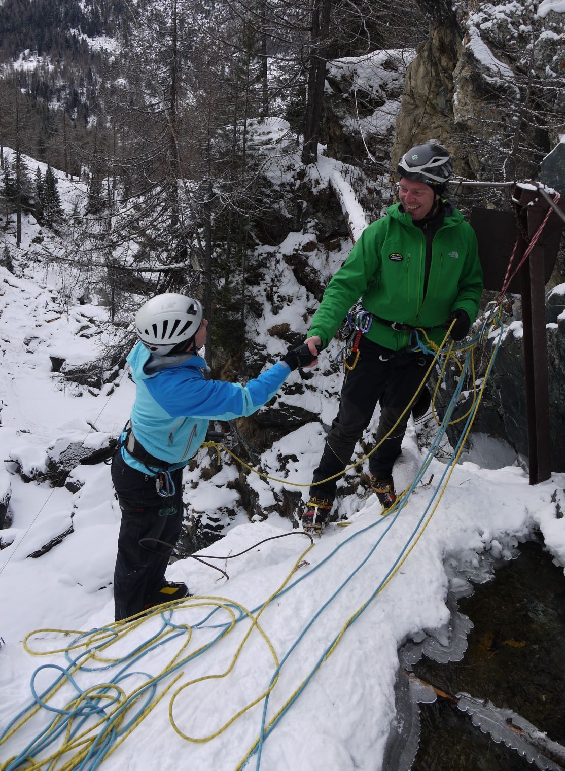Guide and client shaking hands at top of pitch in Lillaz Cogne region