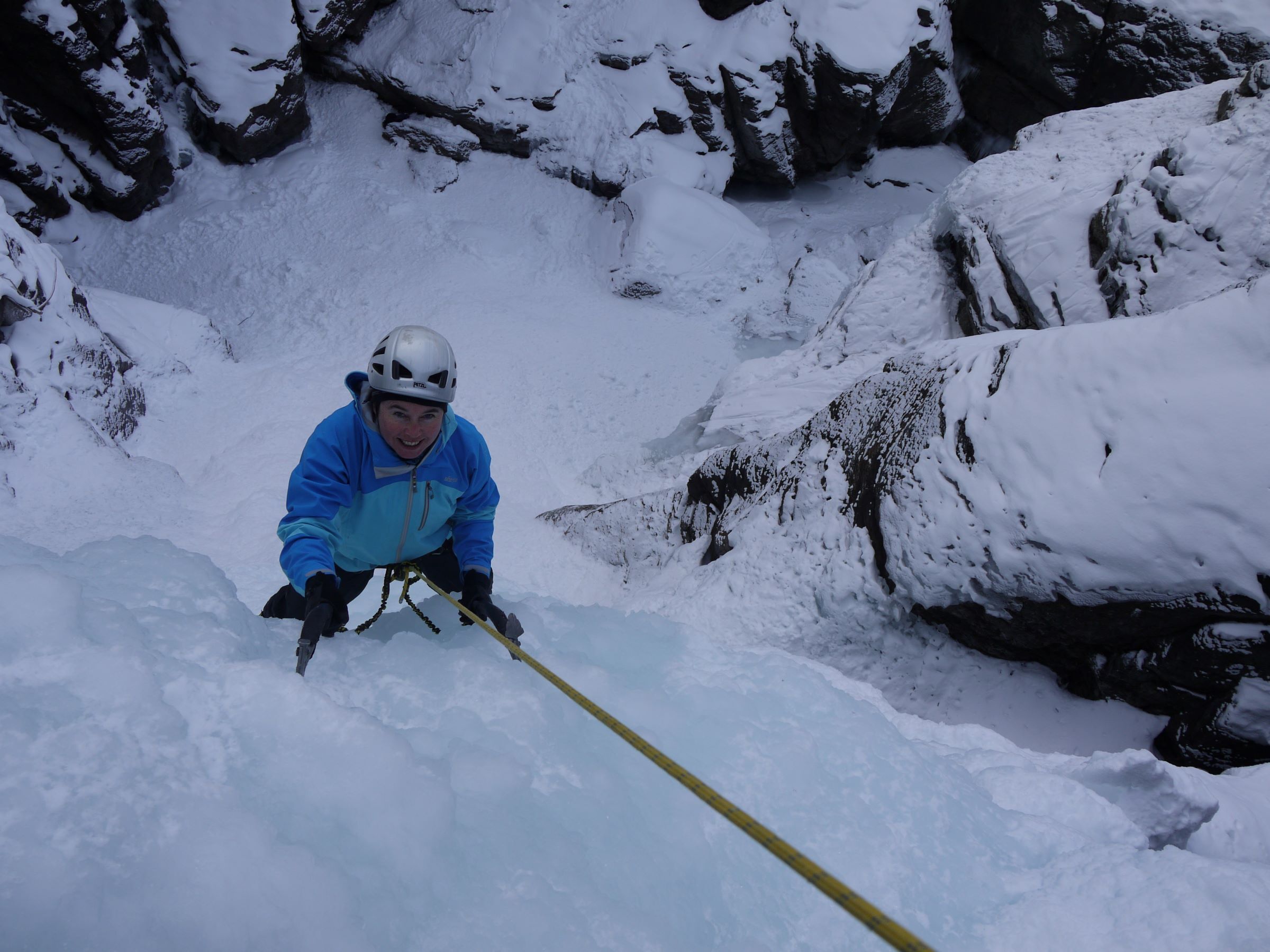 Smiling woman ice climbing in Lillaz Cogne