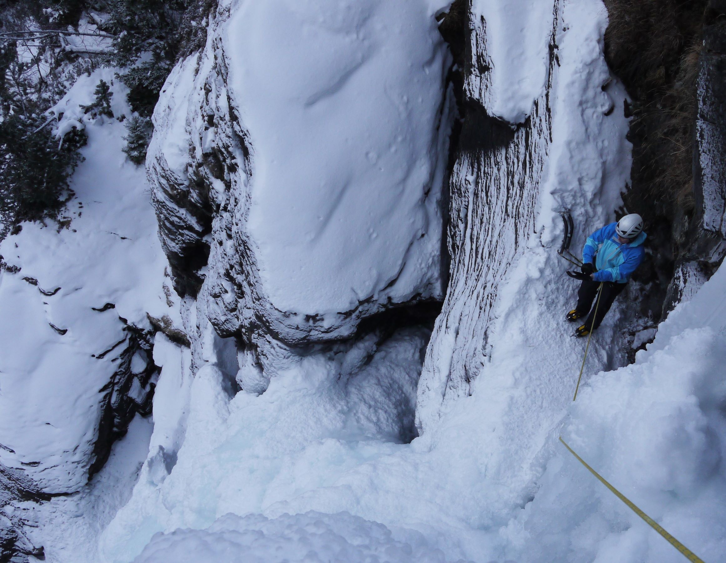 ice climber in cave in Lillaz Cogne about to climb
