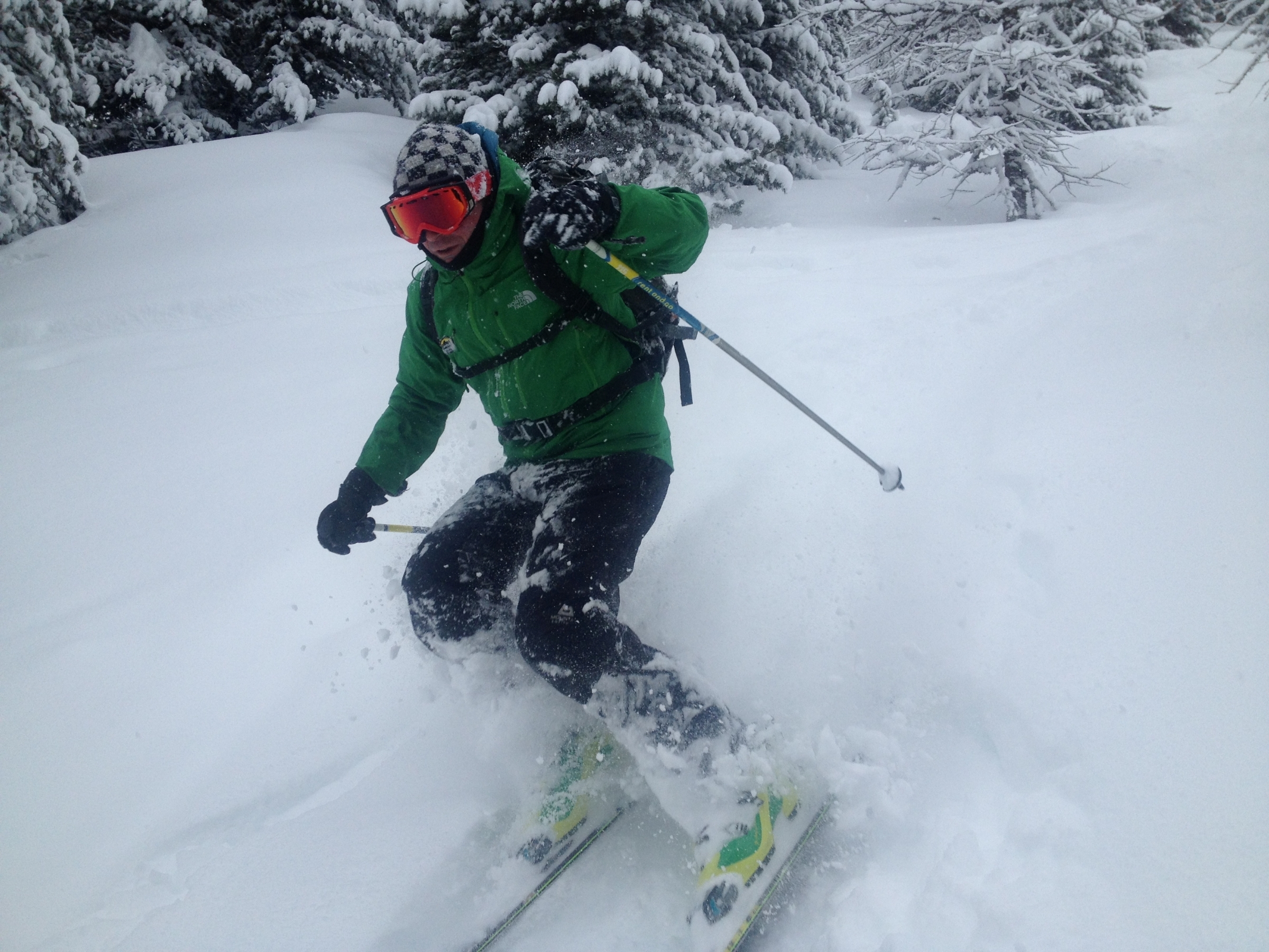 A skier negotiates their way through trees on the lower slopes in France