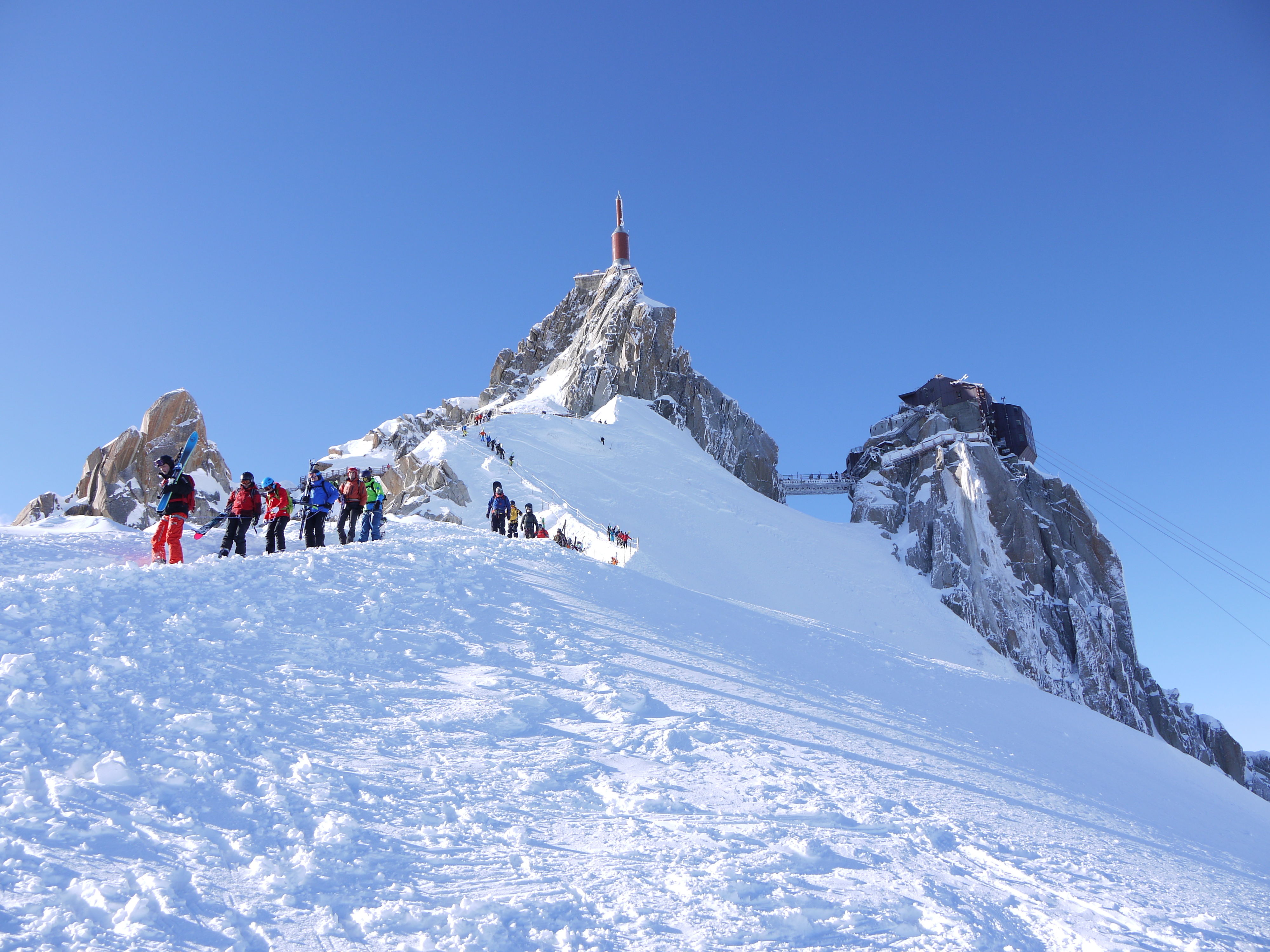 Looking up at a group of skiers descending off Aiguille du Midi, Chamonix France.