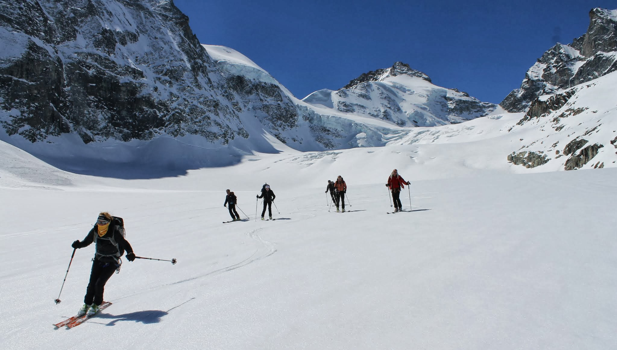 Skiers descend wide open glaciers on the Haute Route