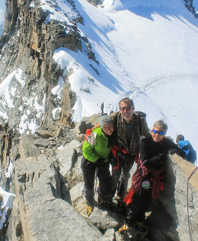 A team all smiles as the rest on the ridge of Gran Paradiso, not far from the summit.