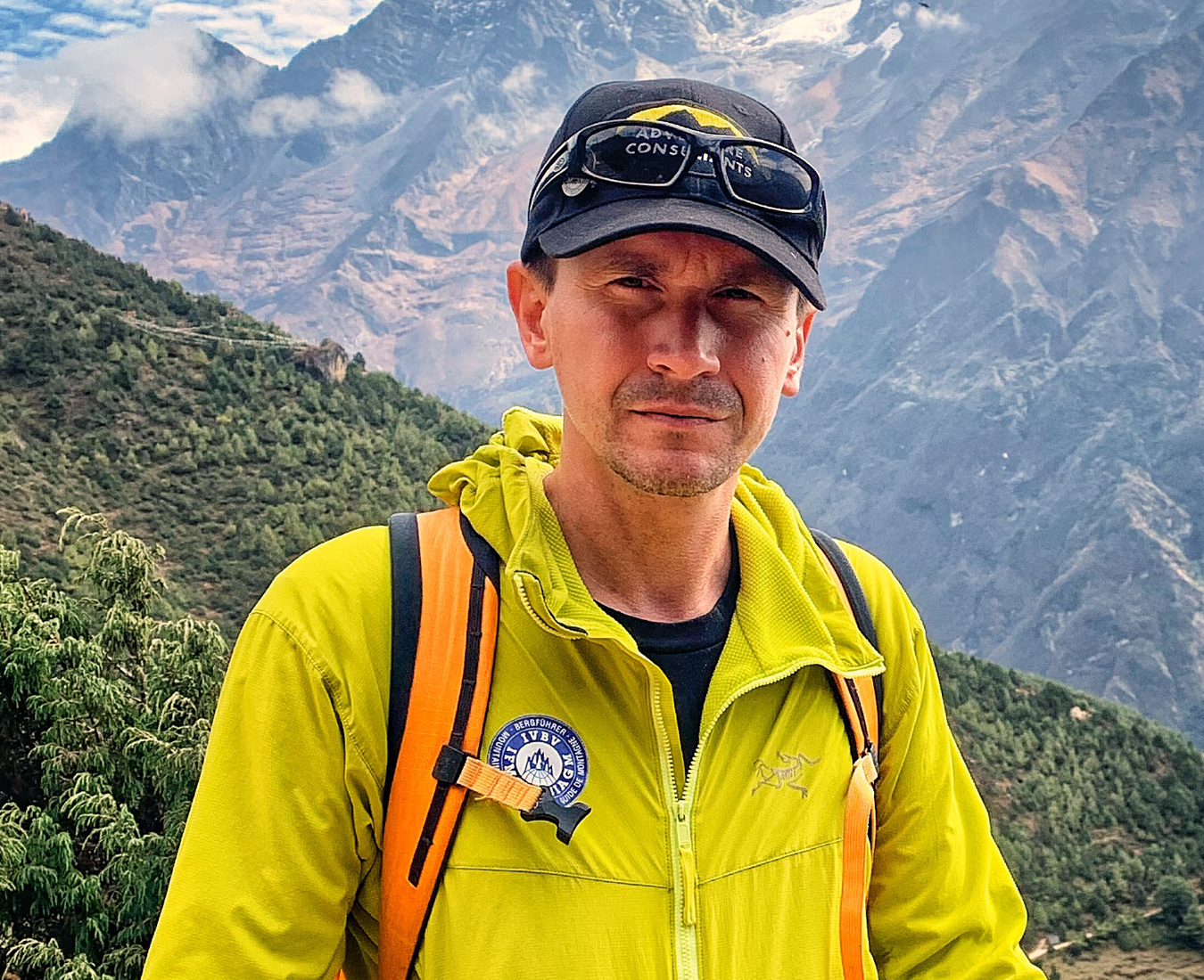 Cosmin Andron, Adventure Consultants IFMGA Mountain & Ski Guide stands high above the Nepalese village of Namche Bazaar, Khumbu Valley.