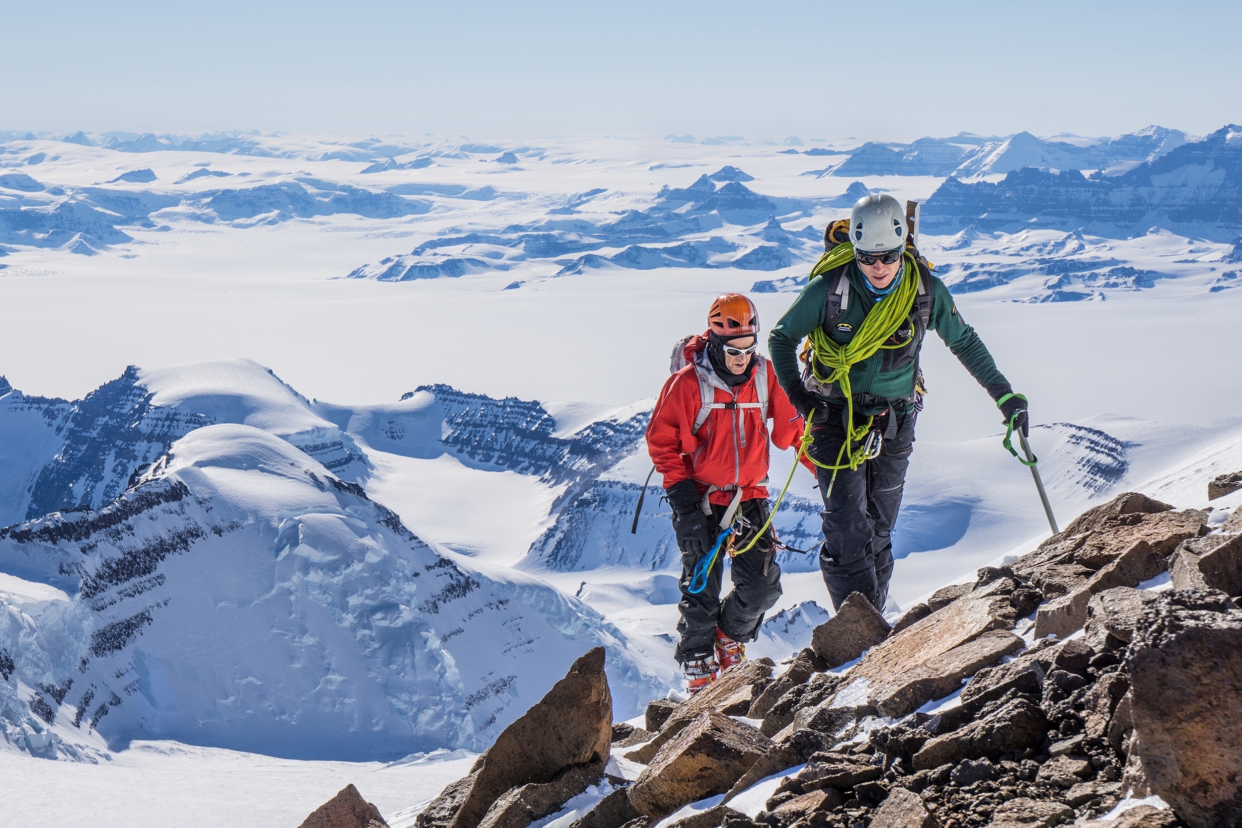 An IFMGA AC Guide short-ropes a climber in the Watkins Mountains, Greenland.