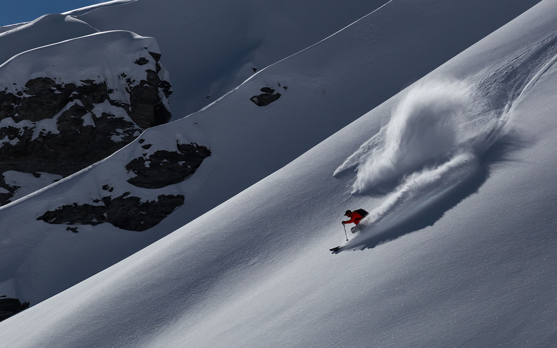 Andy Cole AC IFMGA Mountain and Ski guide get fresh tracks in spring snow deep in the New Zealand backcountry.