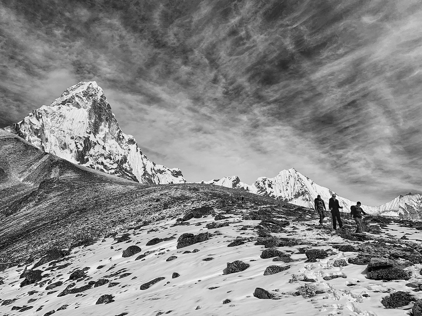 Climbers descend from Ama Dablam Base Camp, the mountain standing tall in the background