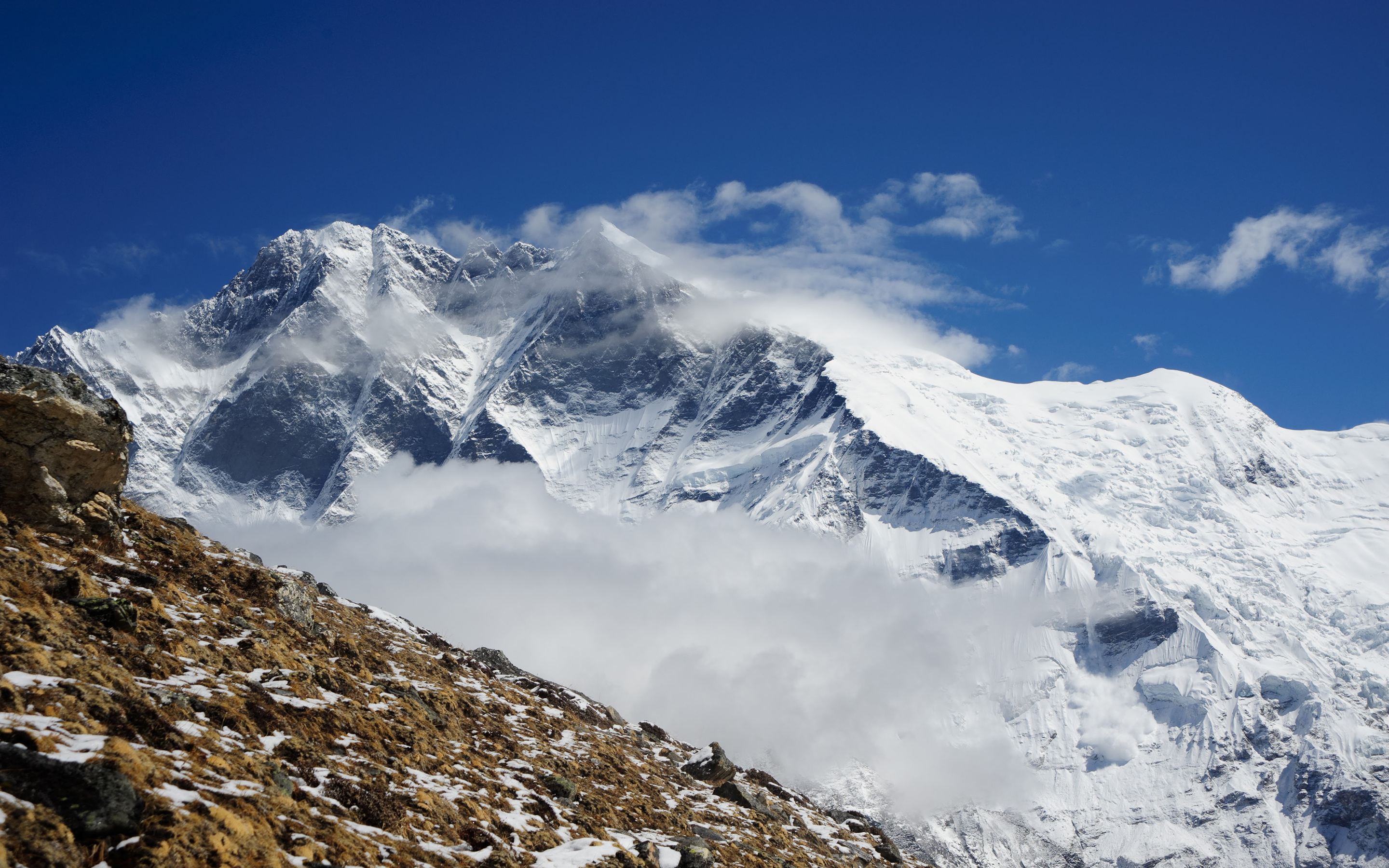 Cloud surrounds the imposing peak of nearby Mount Makalu from the slopes of Baruntse.