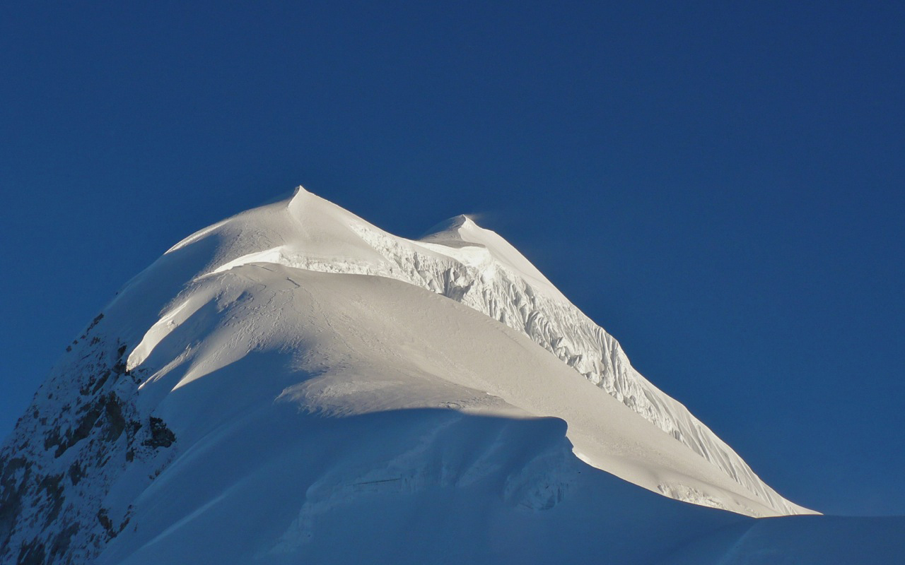 Looking up the summit slopes of Baruntse, bright cloudless blue skies ahead!