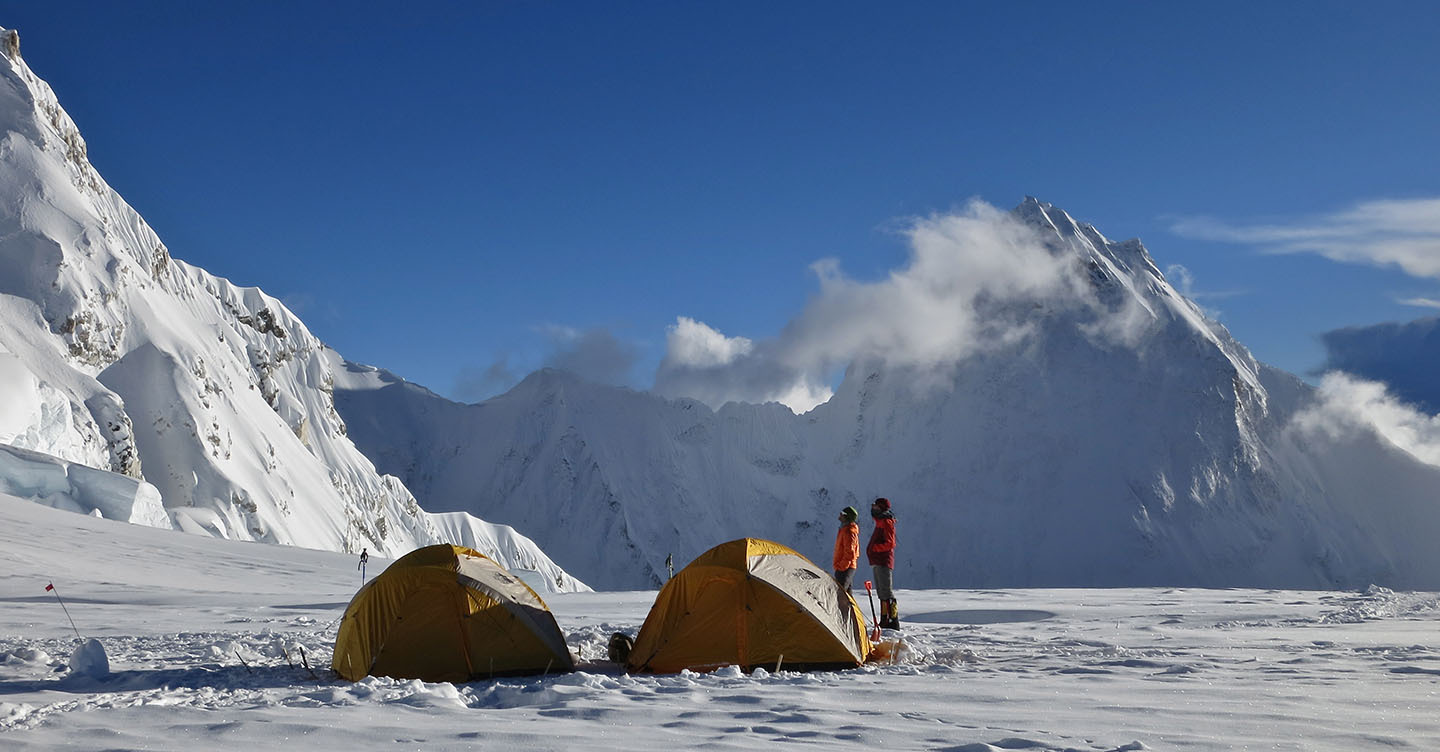Climbers contemplate the route above Camp 2 on Cho Oyu