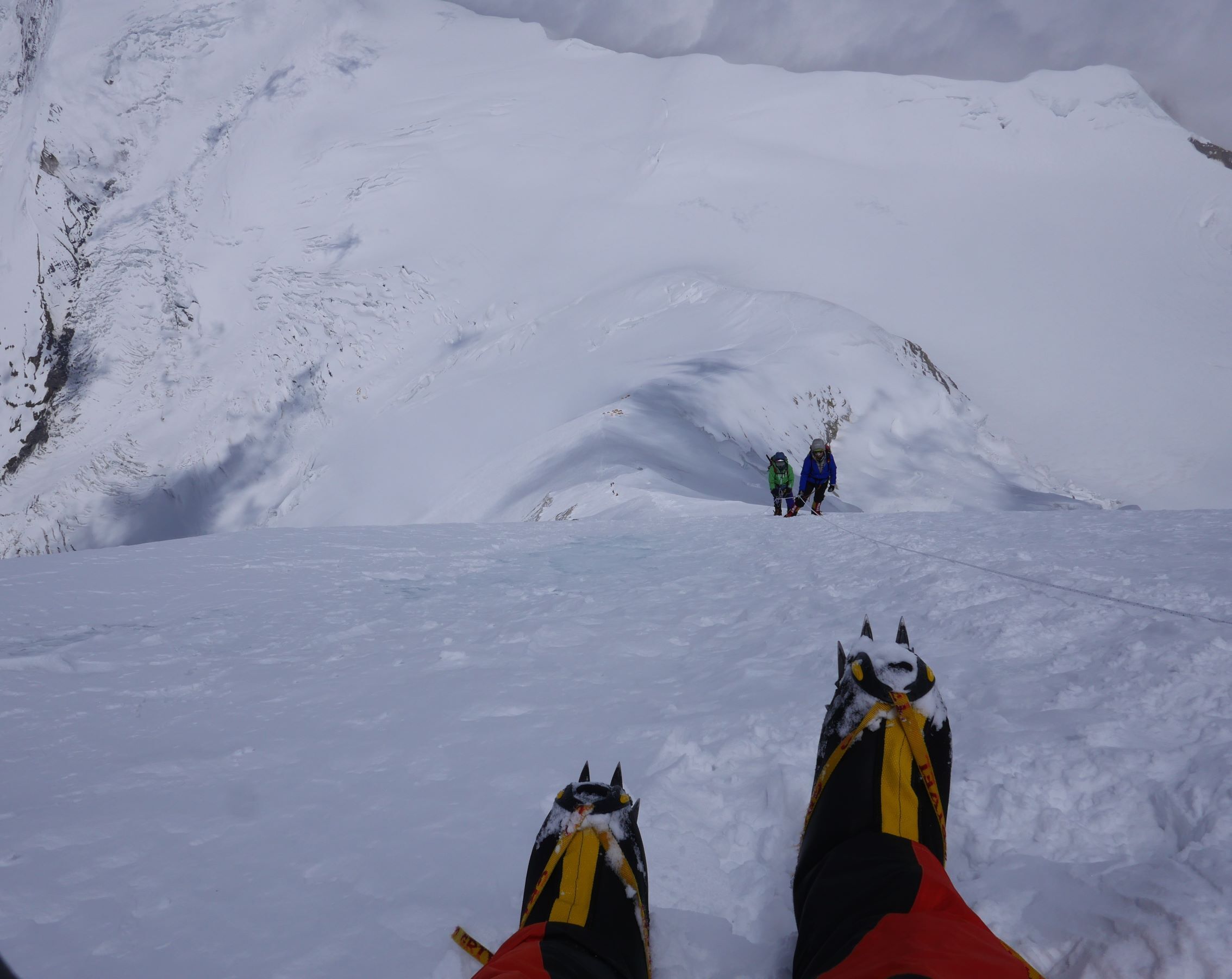 Climbers feet with climbers below on Nth ridge Dhaulagiri