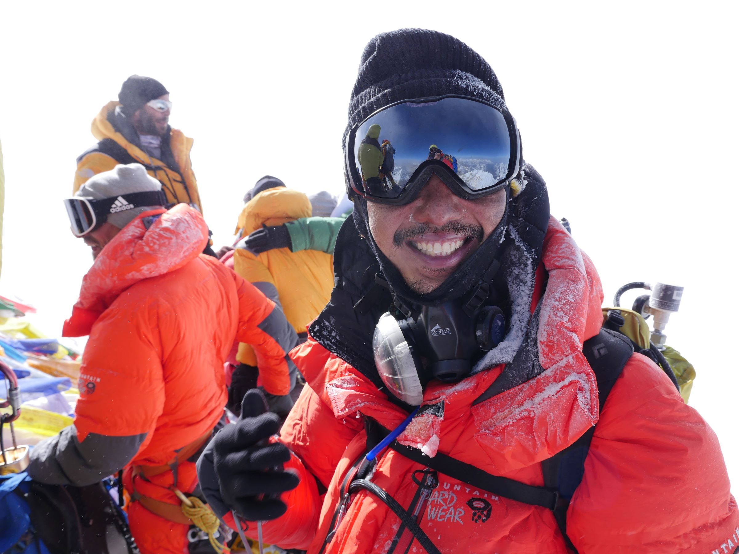Happy climber on summit of Mt Everest