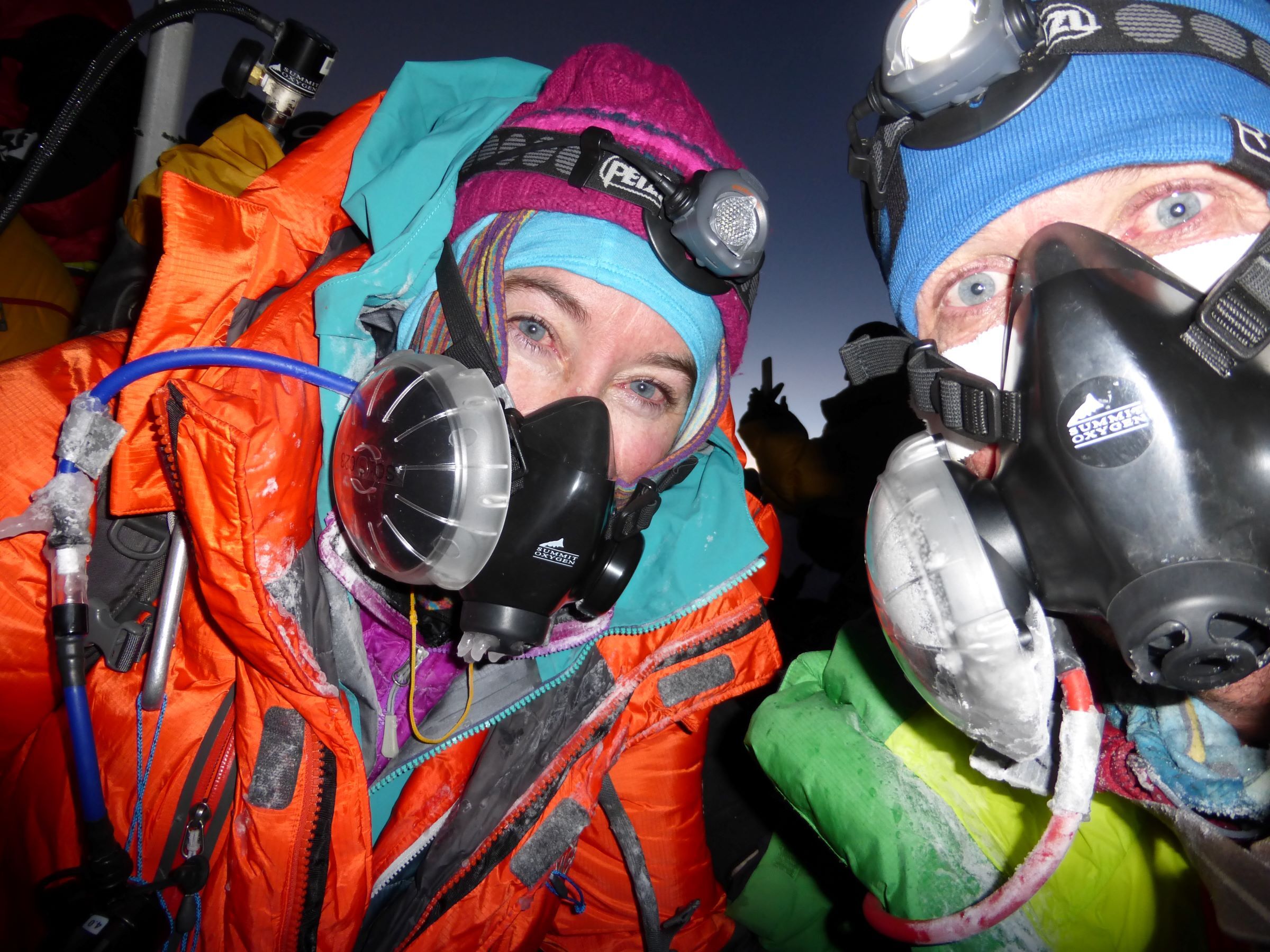 Climbers in oxygen masks on Mt Everest at night
