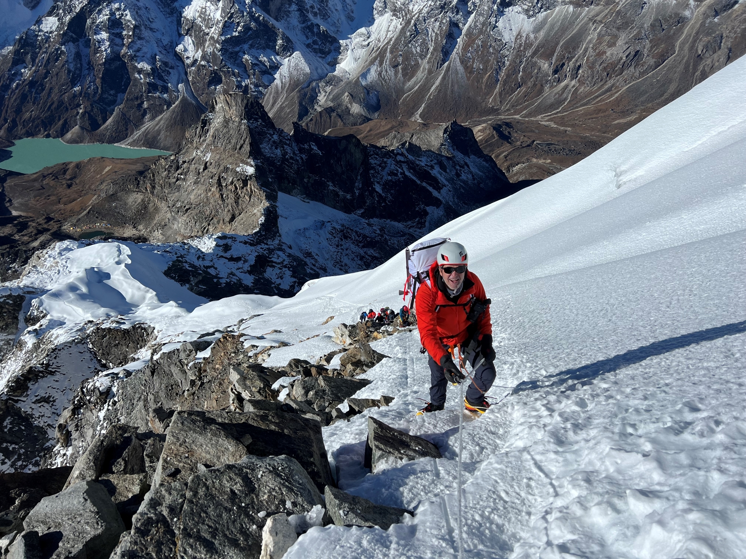 Approaching the summit of Lobuche East on fixed ropes with the Lobuche lake below
